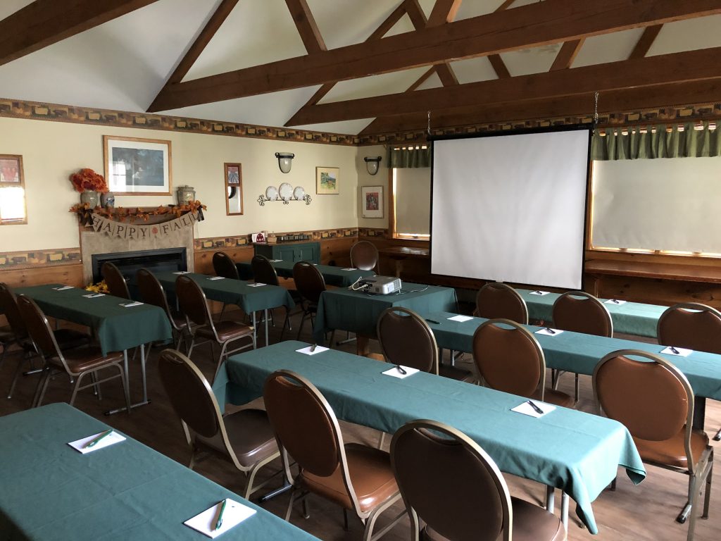 conference space with projector and screen in small dining room at east hill farm