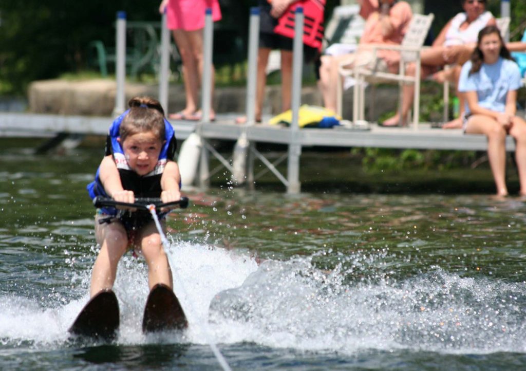 Yound girl waterskiing at east hill farm's property at silver lake 