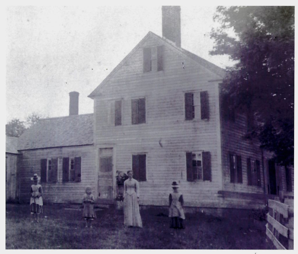 The Whitcomb children in front of east hill farm house