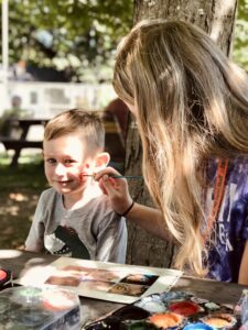 boy getting his face painted at east hill farm